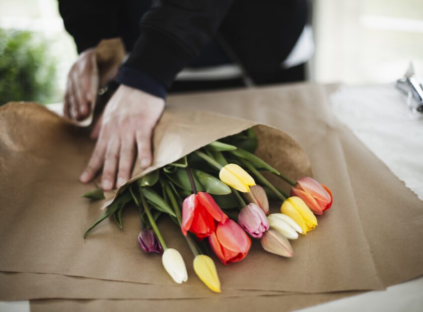 Bunch of rainbow tulips in brown paper wrap