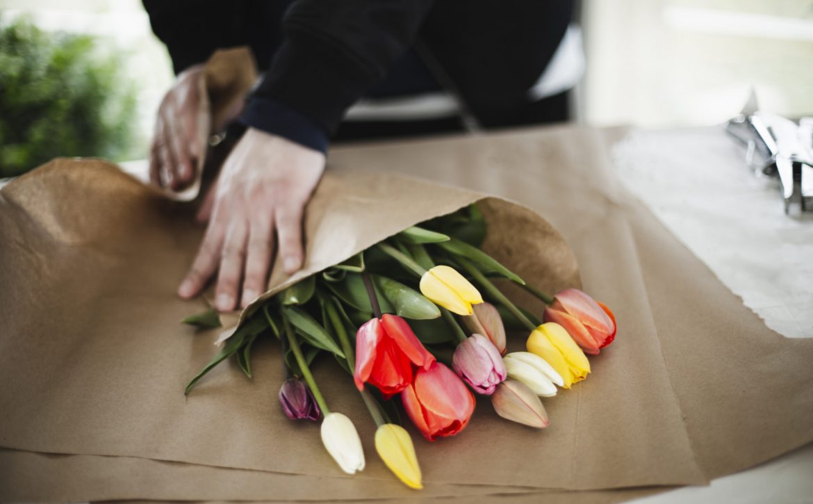 Bunch of rainbow tulips in brown paper wrap
